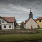 Małe wielkopolskie miasteczko z kościółkiem pod pochmurnym niebem
